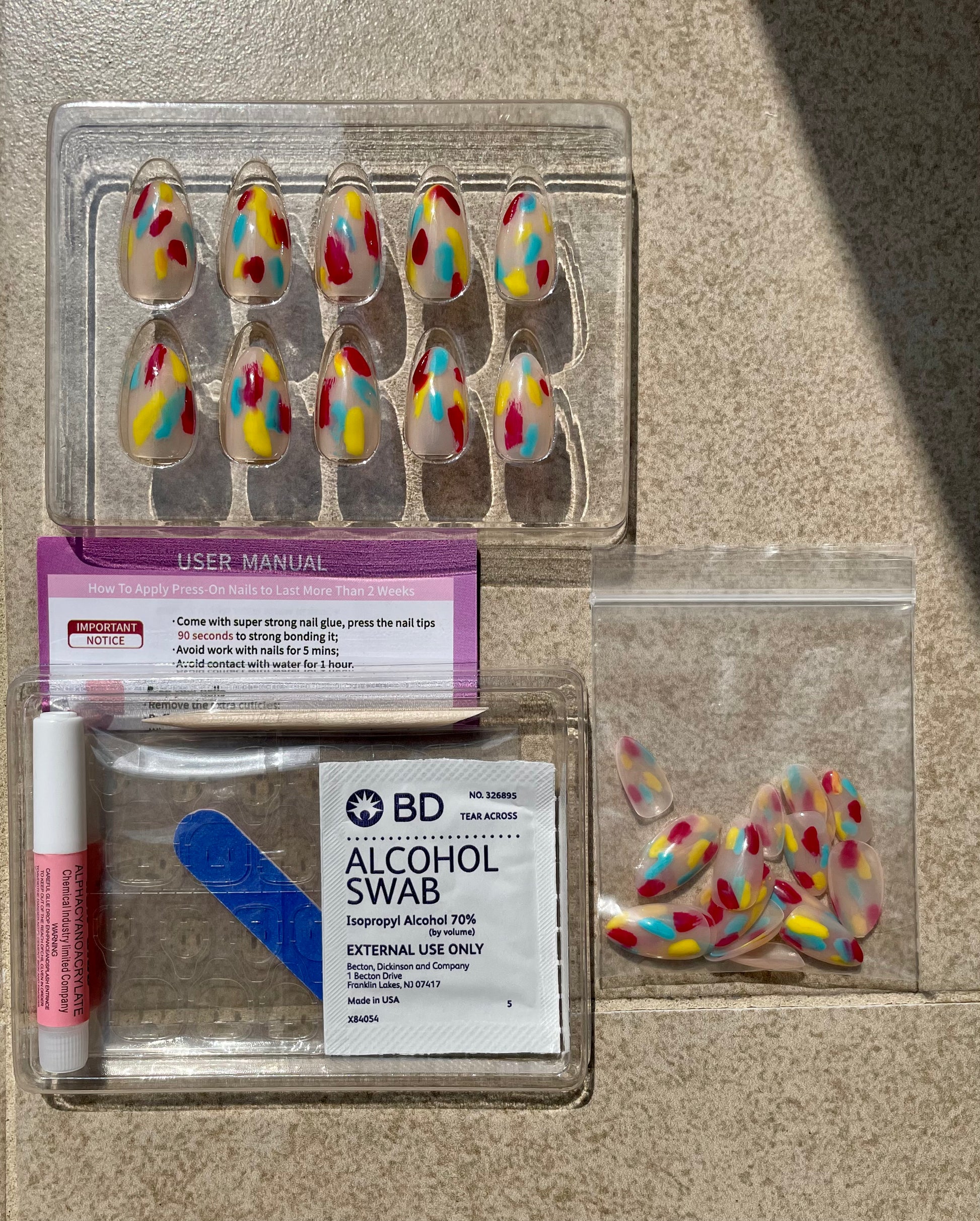 Short Colorful yellow, blue, red Jazzy Almond press-on nails with nail glue, alcohol swab, user manual, double sided nail file, cuticle stick and gel nail tabs made by Leewa Beauty