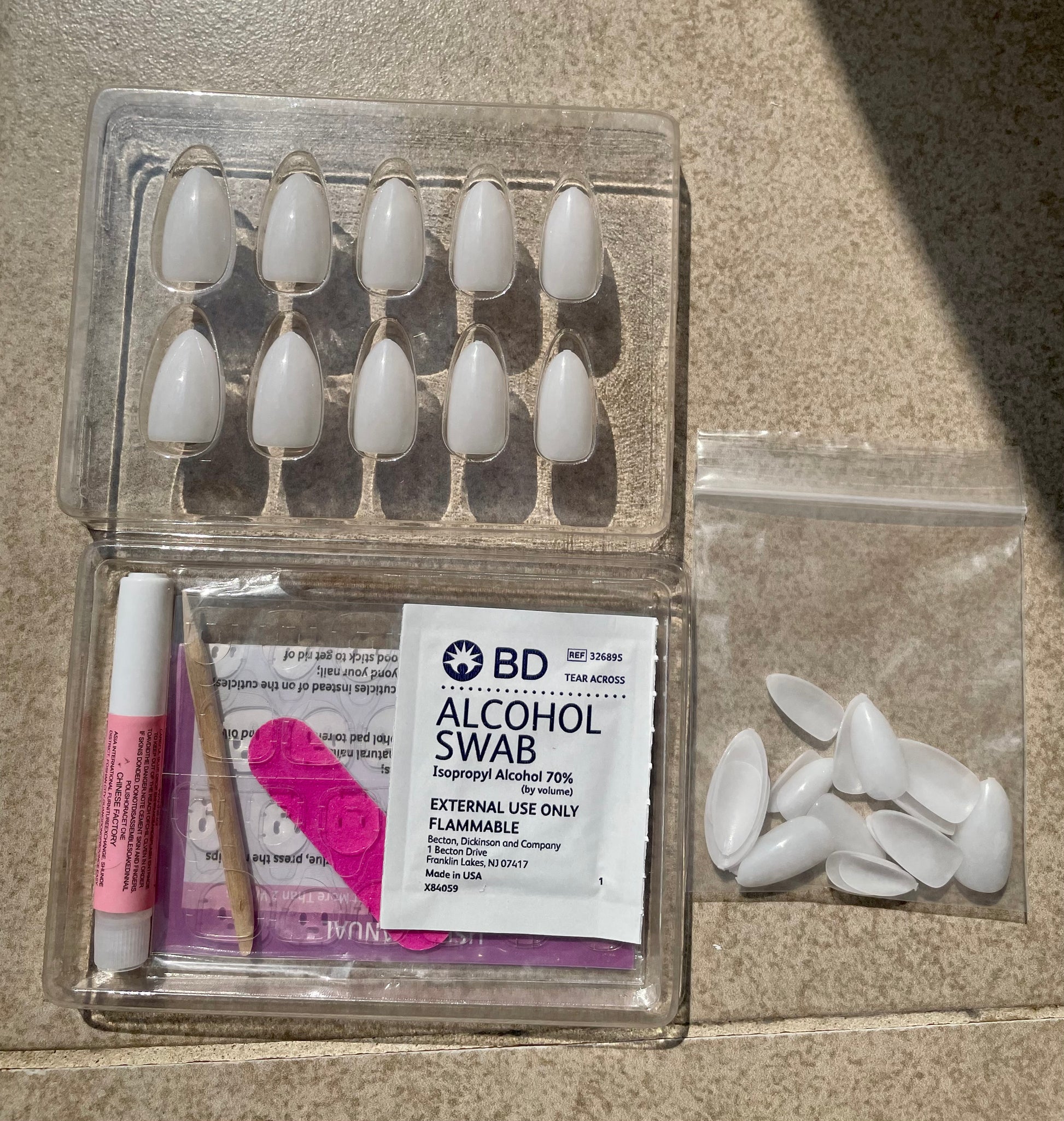 Reusable Soft Gel Milky White Almond Press-on nails with nail kit that include nail glue, gel nail tabs, alcohol swab, cuticle stick, doubled sided nail file and instructions made by Leewa Beauty