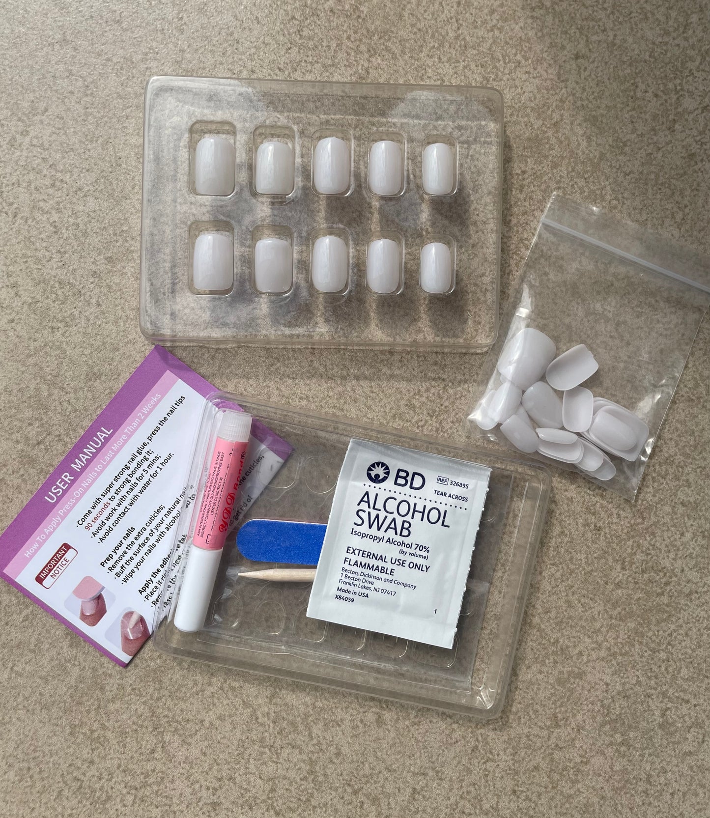 Glossy Milky White Square Press-on Nails and Nail kit that include user manual, glue, gel nail tabs, alcohol pad, double sided nail file and cuticle stick made by Leewa Beauty