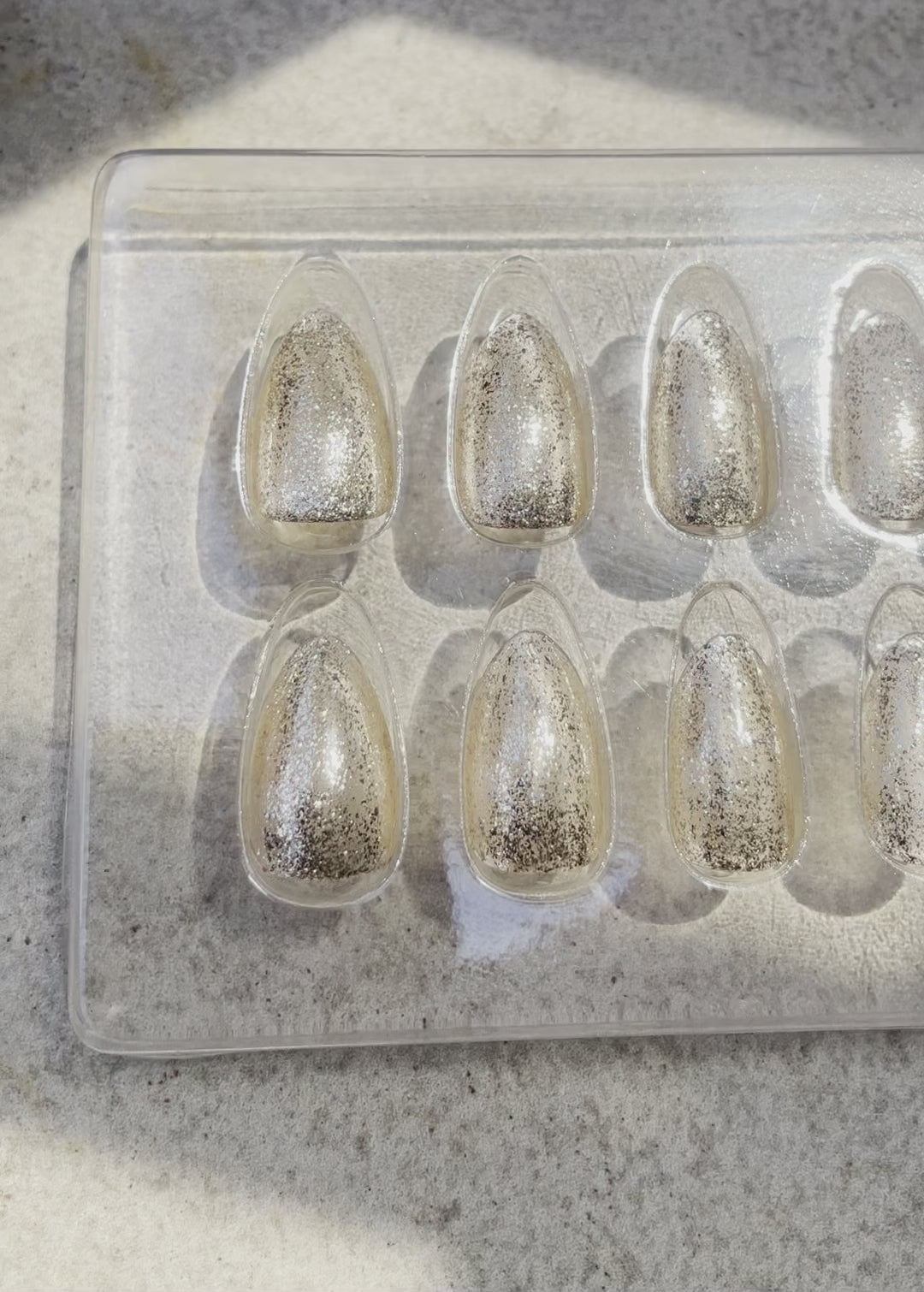Reusable short almond press-on nails with shimmery gold finish named 24 karat Almond by Leewa Beauty