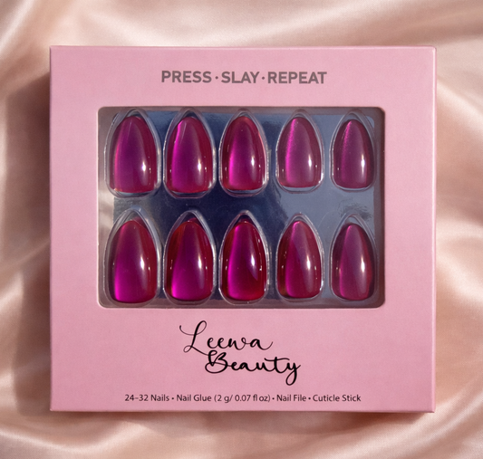 Pink and reddish cat eye design nail kit on a pink satin background