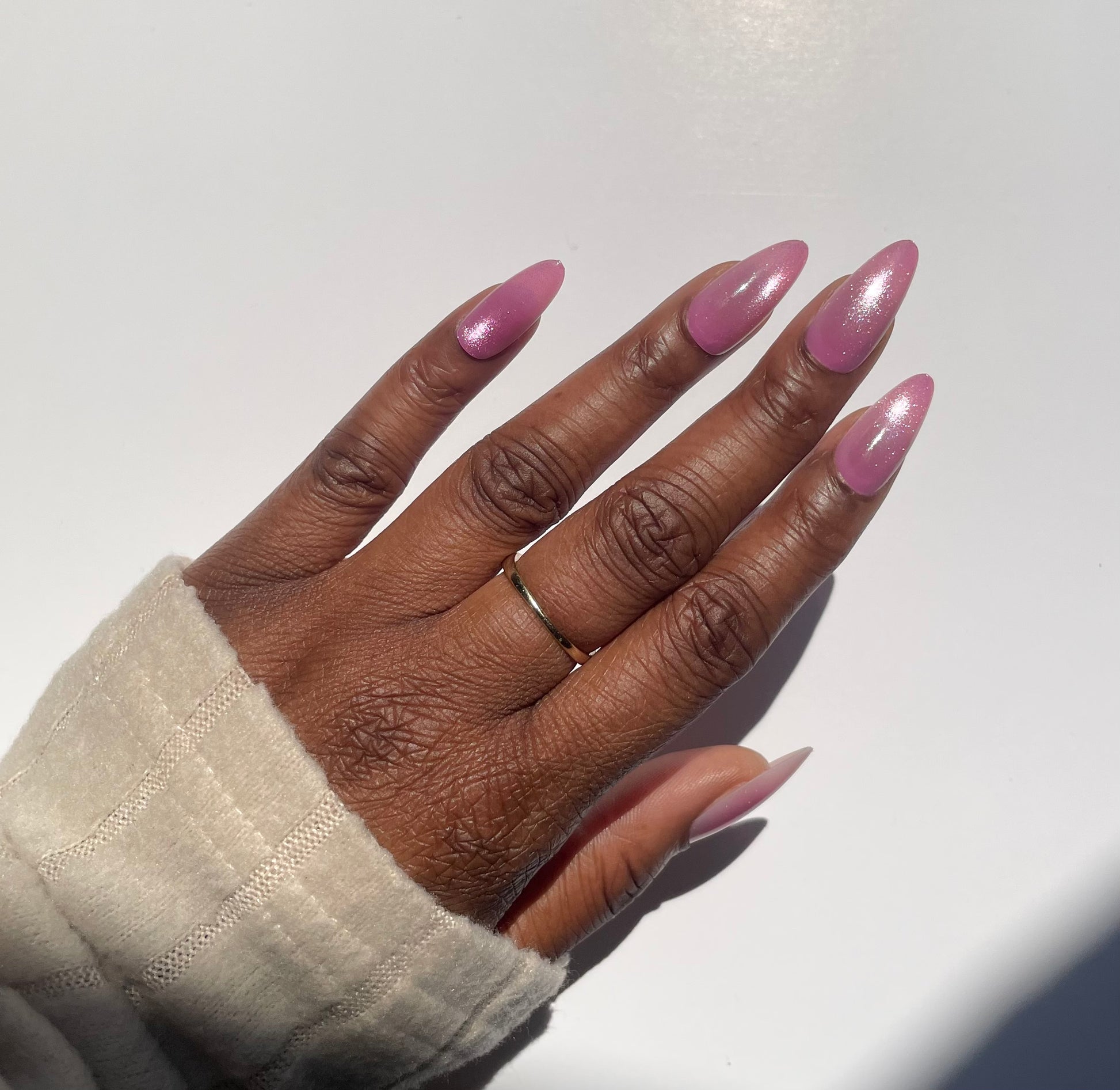 Amara medium pink cat eye almond press-on nails worn on hand - side view