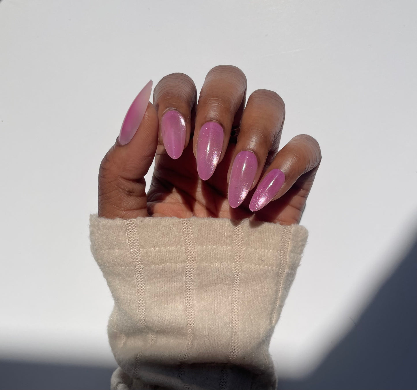 Amara medium pink cat eye almond press-on nails worn on hand - front view