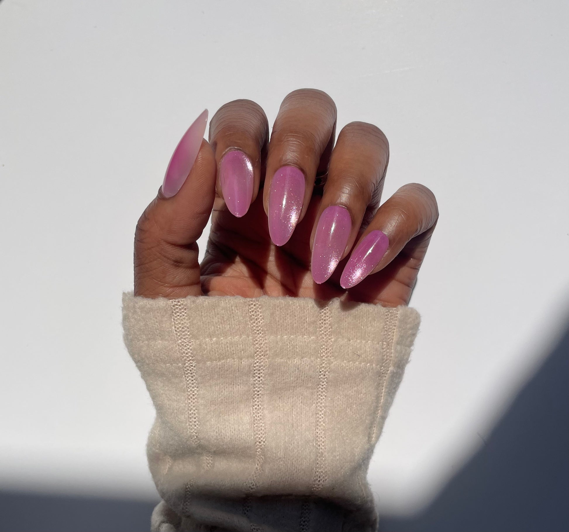 Amara medium pink cat eye almond press-on nails worn on hand - front view