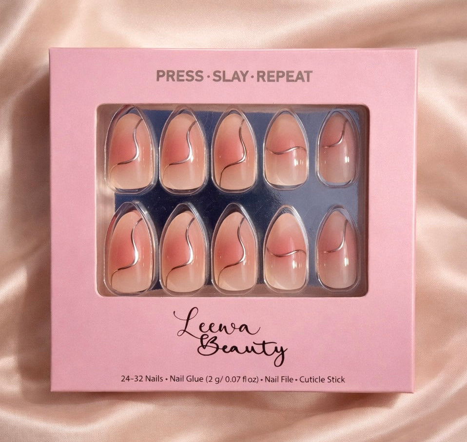 Pink box of press-on nails with 'Leewa Beauty' branding on a satin background