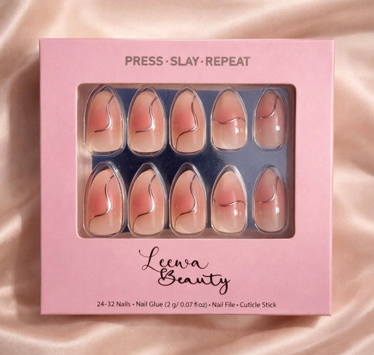 Pink box of press-on nails with 'Leewa Beauty' branding on a satin background