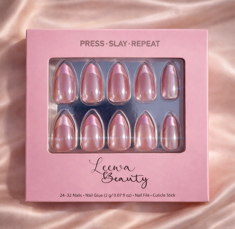 Pink nail art set with 'Press Slay Repeat' text on a pink satin background